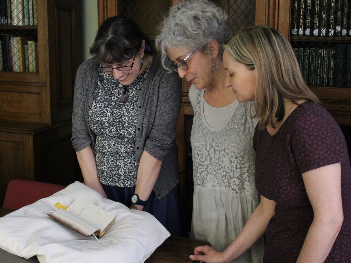 Alison Cullingford, Suzanne Trill and Cordelia Beattie viewing an Alice Thornton manuscript in Durham Cathedral 