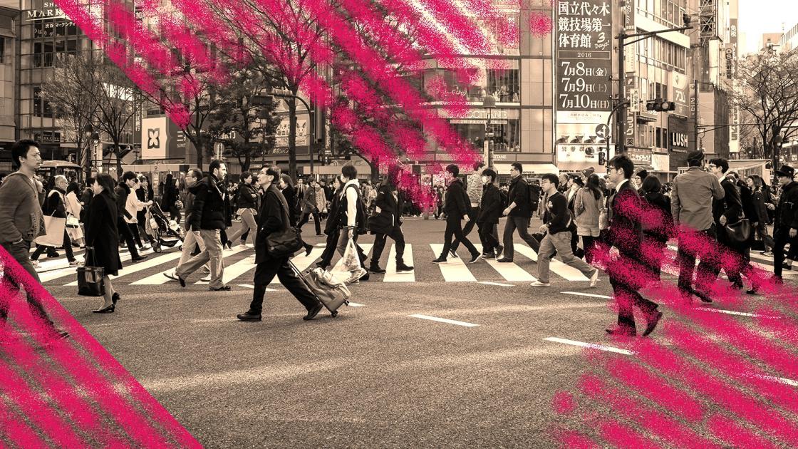 Busy intersection in a city with pink graphics on top