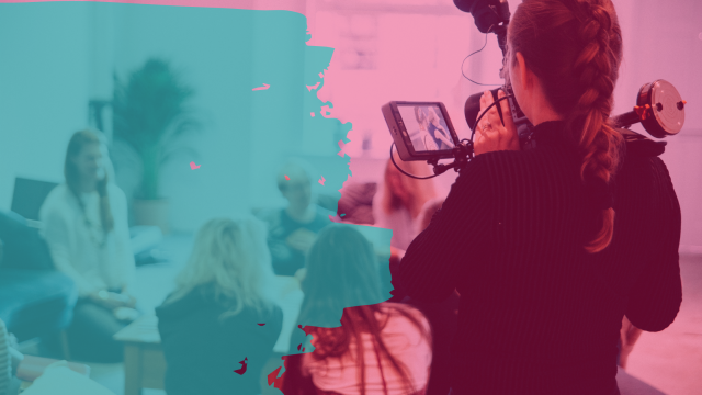 image of a camera person filming a group